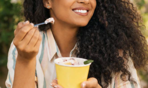 Woman eating an ice-cream rich in fiber